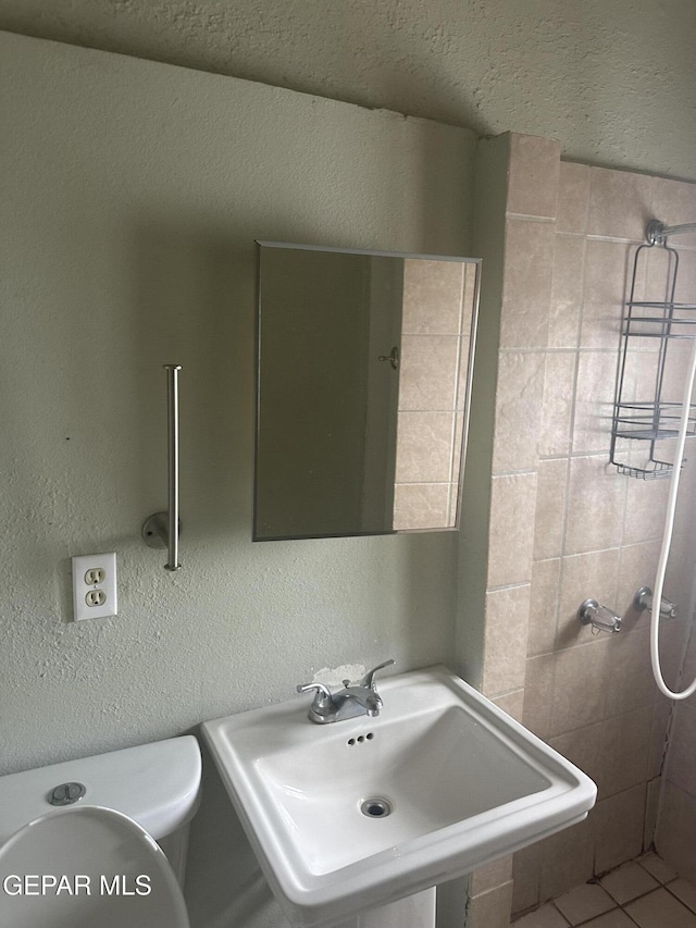 3506 Pera Ave Unit A & B, El Paso, TX 79905 - bathroom with a sink, a textured wall, and toilet