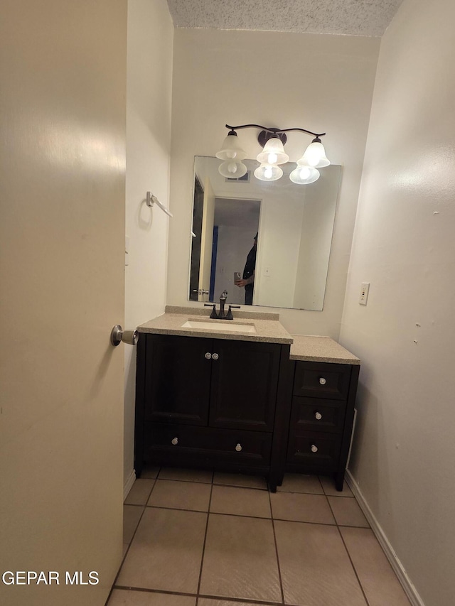 425 Irondale Dr Unit E, El Paso, TX 79912 - bathroom featuring tile patterned floors, vanity, and baseboards