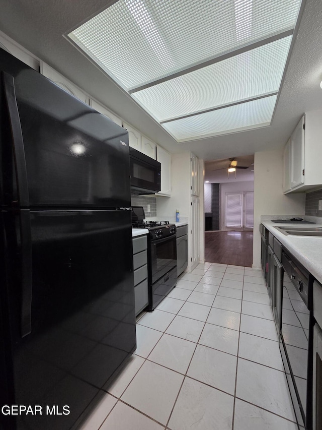 425 Irondale Dr Unit E, El Paso, TX 79912 - kitchen with black appliances, a sink, light tile patterned floors, and light countertops