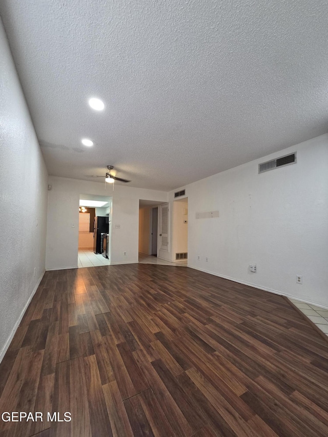 425 Irondale Dr Unit E, El Paso, TX 79912 - unfurnished living room with a textured ceiling, wood finished floors, ceiling fan, recessed lighting, and baseboards