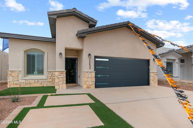 157 Bonnie Trl, Santa Teresa, NM 88008 - view of front of home featuring driveway, stucco siding, stone siding, and an attached garage