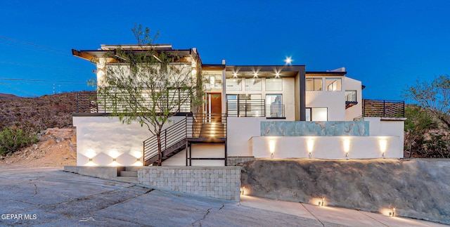 4108 Metetuye Ln, El Paso, TX 79902 - modern home featuring stairs, a balcony, and stucco siding