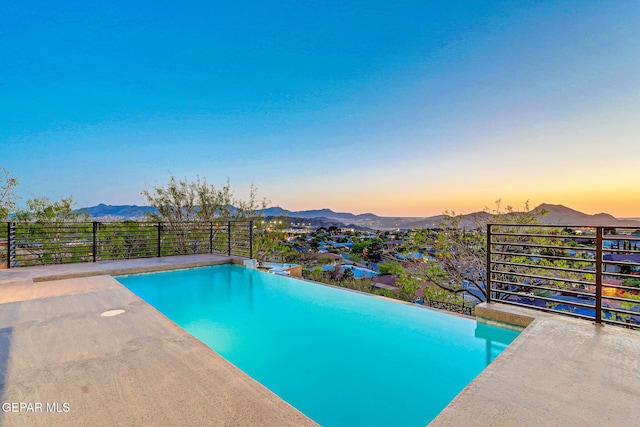 4108 Metetuye Ln, El Paso, TX 79902 - pool at dusk with an infinity pool and a mountain view