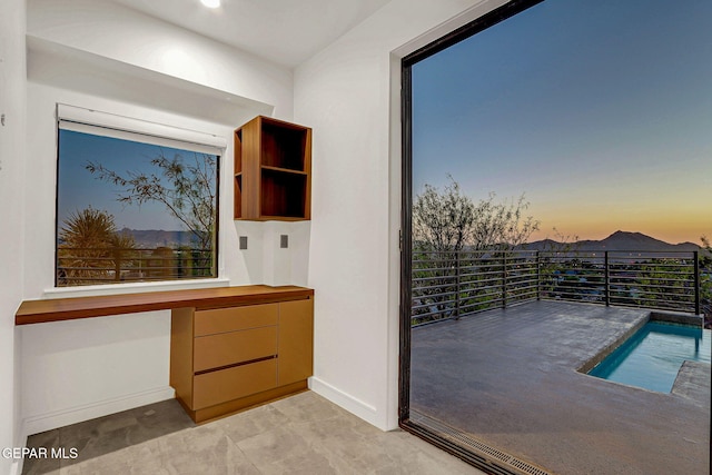 4108 Metetuye Ln, El Paso, TX 79902 - doorway featuring built in desk and baseboards