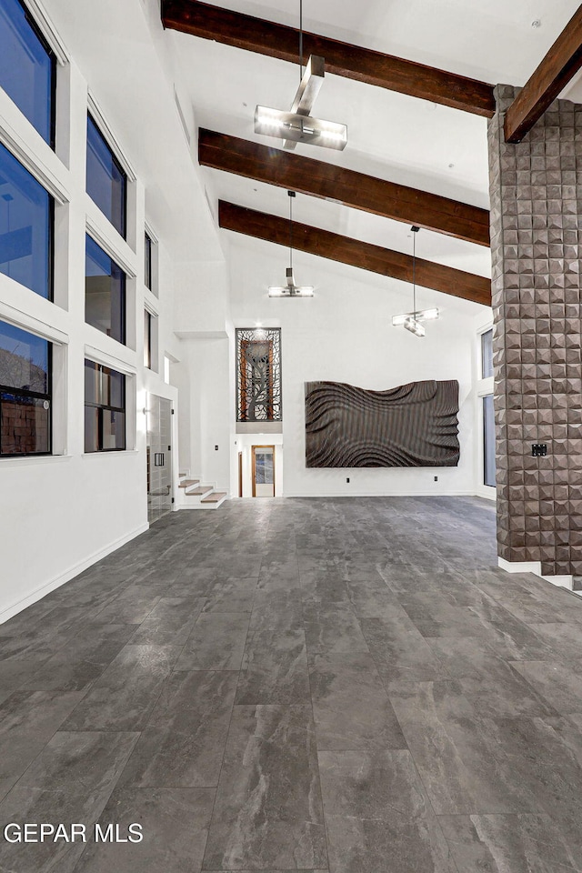 4108 Metetuye Ln, El Paso, TX 79902 - unfurnished living room with lofted ceiling with beams and ceiling fan with notable chandelier