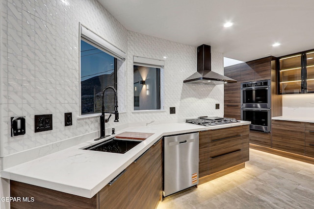 4108 Metetuye Ln, El Paso, TX 79902 - kitchen with wall chimney exhaust hood, modern cabinets, a sink, appliances with stainless steel finishes, and decorative backsplash