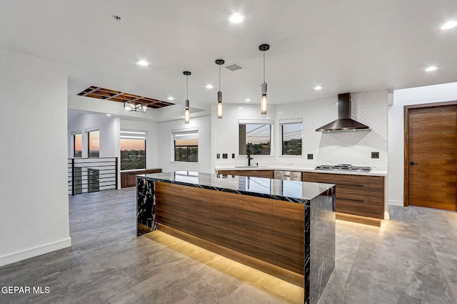 4108 Metetuye Ln, El Paso, TX 79902 - kitchen featuring wall chimney exhaust hood, modern cabinets, brown cabinetry, visible vents, and a sink