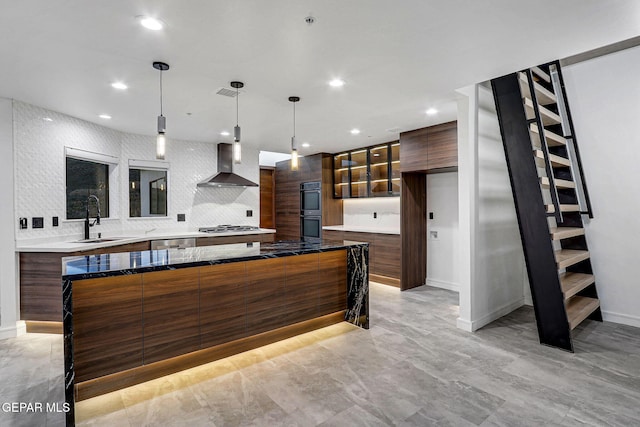 4108 Metetuye Ln, El Paso, TX 79902 - kitchen featuring modern cabinets, tasteful backsplash, wall chimney range hood, appliances with stainless steel finishes, and a large island