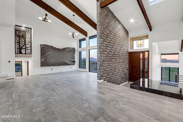 4108 Metetuye Ln, El Paso, TX 79902 - unfurnished living room featuring high vaulted ceiling, a wealth of natural light, and beam ceiling