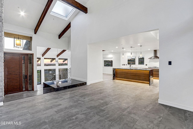 4108 Metetuye Ln, El Paso, TX 79902 - living area with high vaulted ceiling, baseboards, beam ceiling, and a wealth of natural light