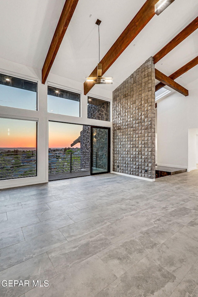 4108 Metetuye Ln, El Paso, TX 79902 - unfurnished living room featuring beamed ceiling, high vaulted ceiling, and a fireplace