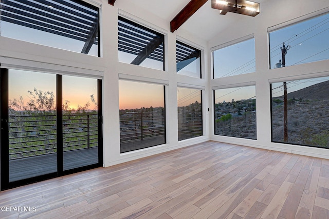 4108 Metetuye Ln, El Paso, TX 79902 - unfurnished sunroom with a healthy amount of sunlight, beam ceiling, and wood finished floors
