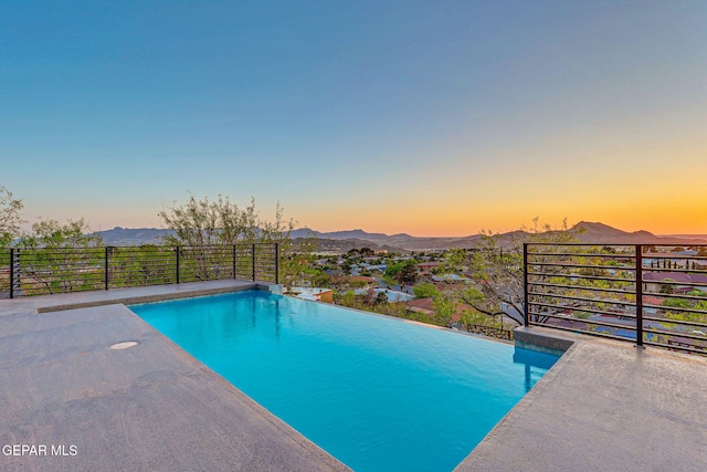 4108 Metetuye Ln, El Paso, TX 79902 - pool at dusk with a mountain view and a fenced in pool