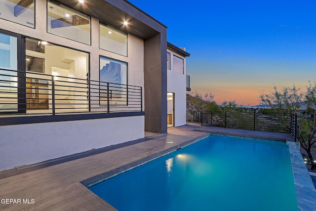 4108 Metetuye Ln, El Paso, TX 79902 - pool at dusk with a fenced in pool and fence