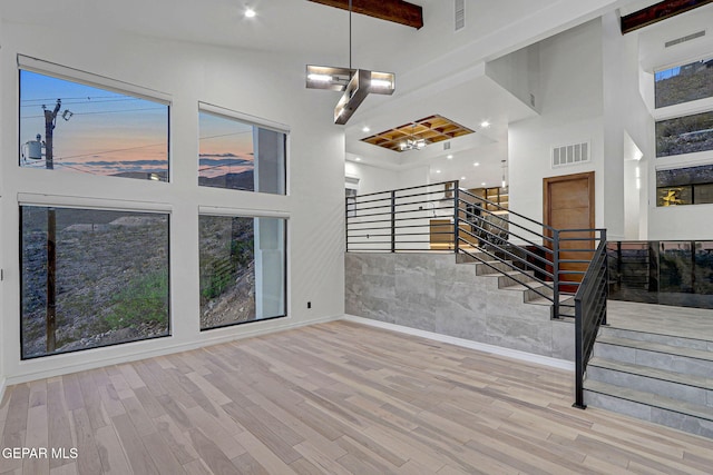 4108 Metetuye Ln, El Paso, TX 79902 - interior space featuring stairs, visible vents, a high ceiling, and wood finished floors