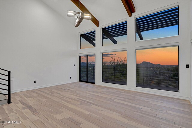 4108 Metetuye Ln, El Paso, TX 79902 - interior space with beam ceiling, baseboards, high vaulted ceiling, and wood finished floors
