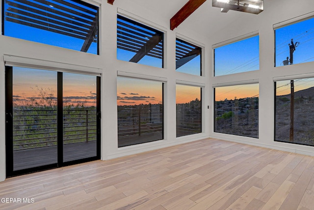 4108 Metetuye Ln, El Paso, TX 79902 - unfurnished sunroom with wood finished floors, a towering ceiling, and beam ceiling