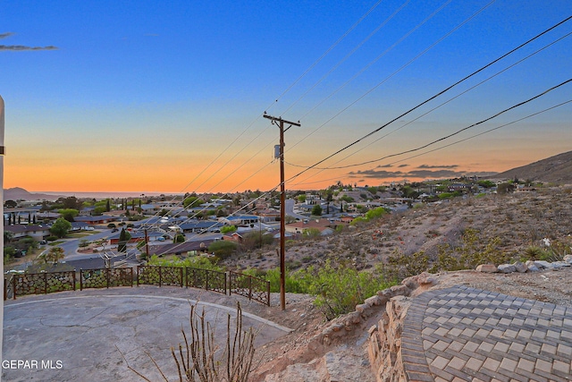 4108 Metetuye Ln, El Paso, TX 79902 - yard at dusk featuring a residential view, fence, and a mountain view