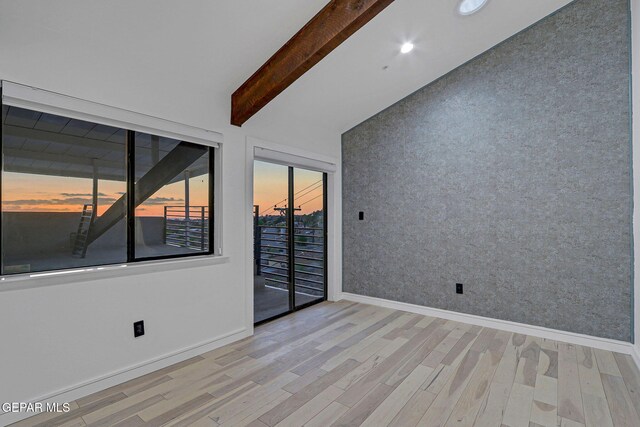 4108 Metetuye Ln, El Paso, TX 79902 - unfurnished room with wood finished floors, baseboards, wallpapered walls, and vaulted ceiling with beams