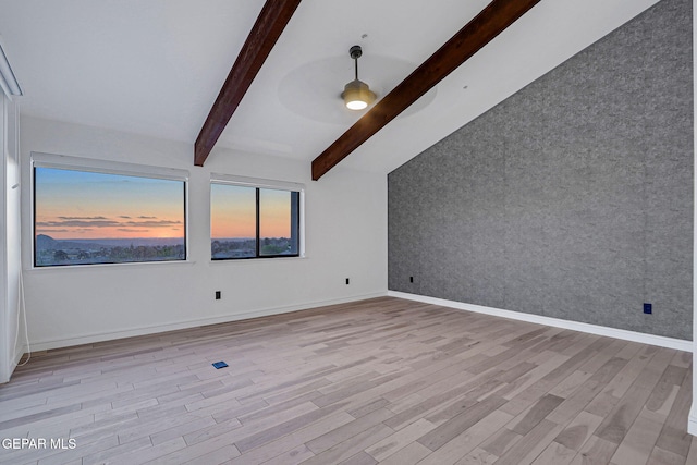 4108 Metetuye Ln, El Paso, TX 79902 - unfurnished room with an accent wall, light wood-type flooring, baseboards, and beam ceiling