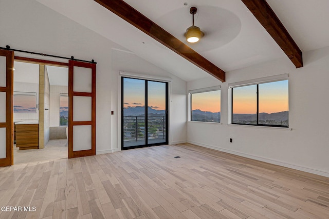 4108 Metetuye Ln, El Paso, TX 79902 - spare room featuring baseboards, lofted ceiling with beams, a barn door, light wood-style floors, and ceiling fan