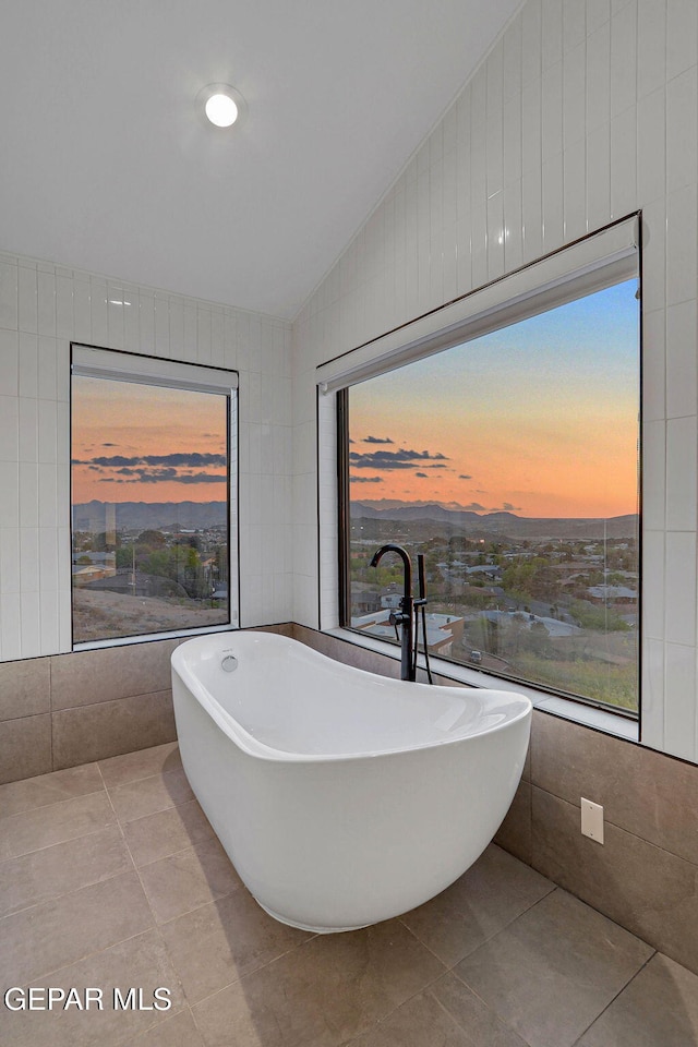 4108 Metetuye Ln, El Paso, TX 79902 - full bath featuring a soaking tub, tile walls, tile patterned flooring, and vaulted ceiling