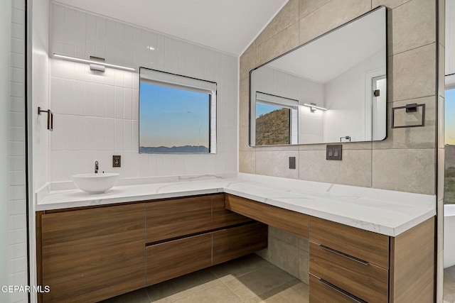 4108 Metetuye Ln, El Paso, TX 79902 - bathroom with vanity, tile patterned flooring, lofted ceiling, and tile walls