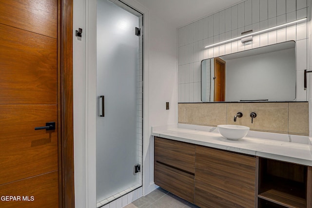 4108 Metetuye Ln, El Paso, TX 79902 - bathroom featuring tile patterned flooring, decorative backsplash, a shower stall, and vanity