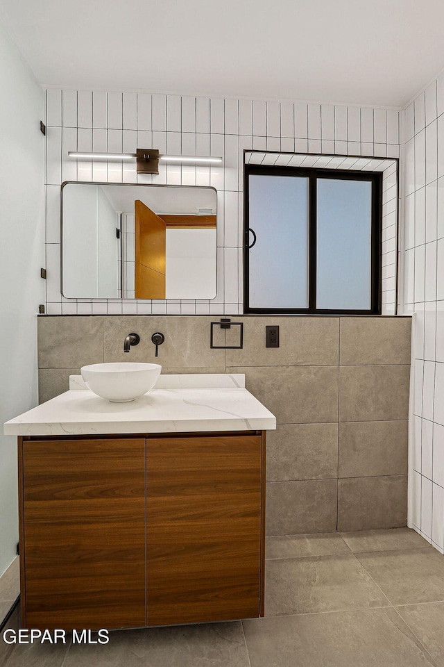 4108 Metetuye Ln, El Paso, TX 79902 - bathroom with tile walls, tile patterned floors, and vanity