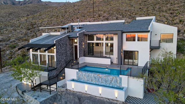 4108 Metetuye Ln, El Paso, TX 79902 - back of property featuring stucco siding, a patio, a balcony, an outdoor pool, and a mountain view