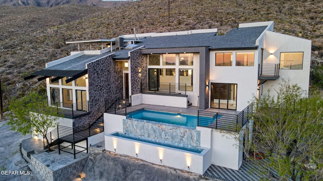 4108 Metetuye Ln, El Paso, TX 79902 - back of property featuring stucco siding, a patio, a balcony, an outdoor pool, and a mountain view
