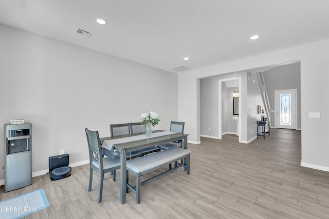 dining area with light wood-style floors, recessed lighting, visible vents, and baseboards