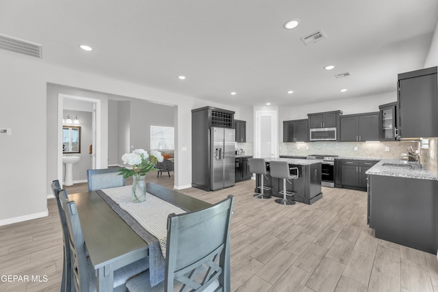 dining area with visible vents, light wood-type flooring, and recessed lighting