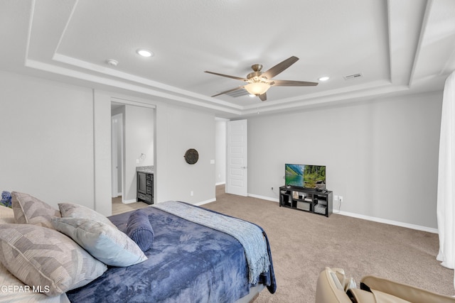 carpeted bedroom with recessed lighting, visible vents, a tray ceiling, and baseboards