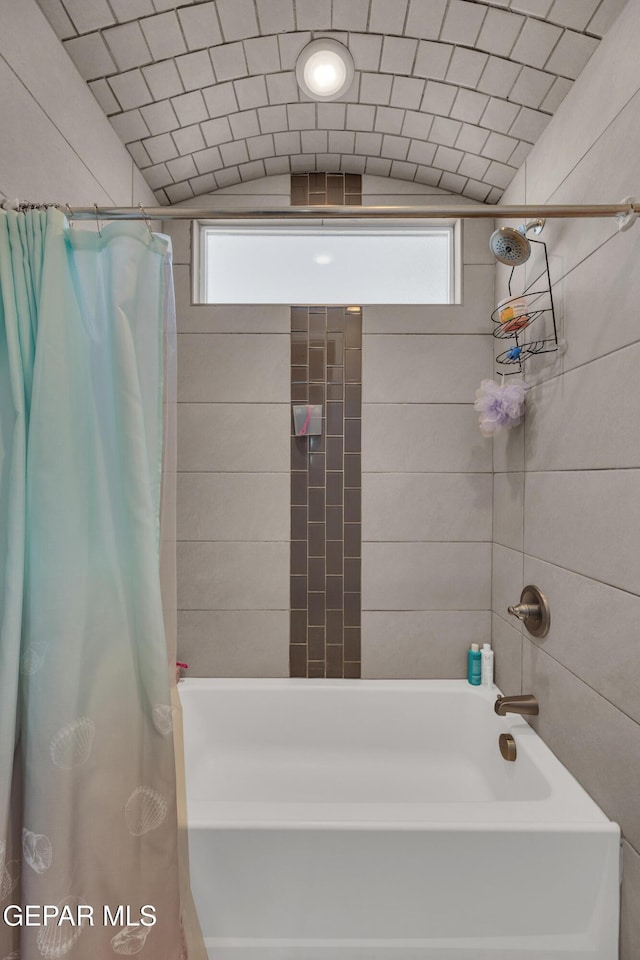 bathroom featuring visible vents, shower / tub combo with curtain, and a healthy amount of sunlight