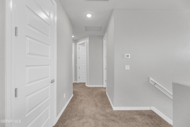hallway featuring baseboards, recessed lighting, attic access, carpet floors, and visible vents