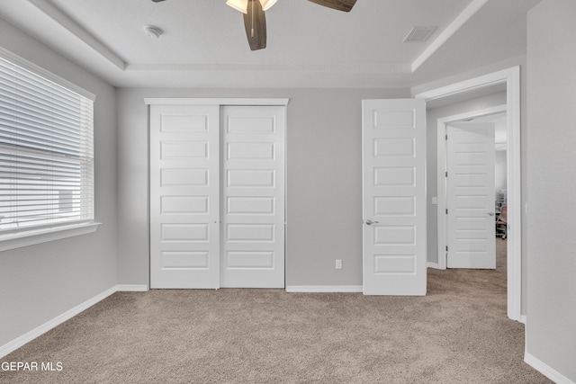 unfurnished bedroom featuring visible vents, baseboards, carpet flooring, and a closet