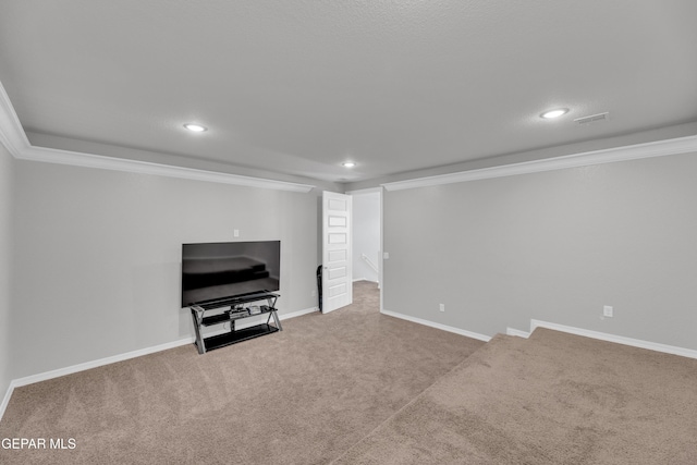 finished basement with crown molding, visible vents, recessed lighting, and carpet flooring