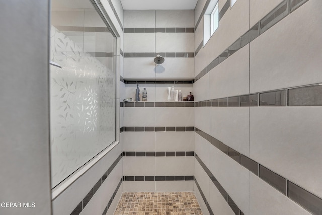 full bathroom with tiled shower