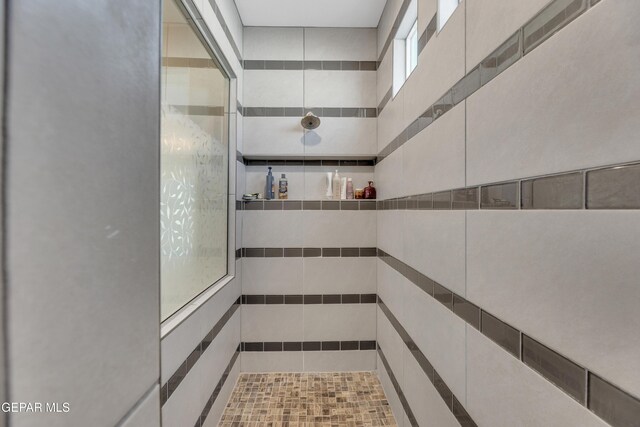 bathroom with a tile shower