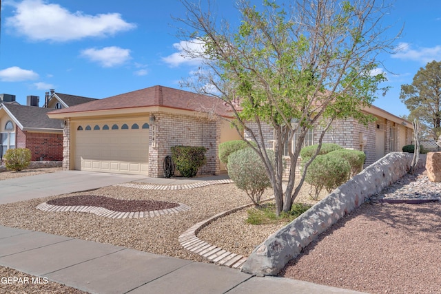 7341 Desierto Rojo Ct, El Paso, TX 79912 - ranch-style house with brick siding, driveway, and a garage
