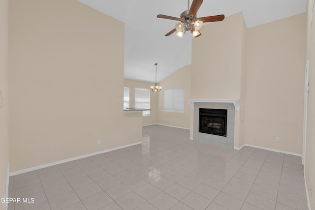 7341 Desierto Rojo Ct, El Paso, TX 79912 - unfurnished living room with high vaulted ceiling, ceiling fan with notable chandelier, light tile patterned floors, a fireplace, and baseboards
