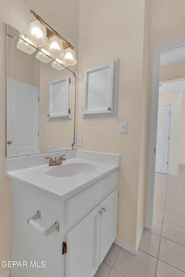 7341 Desierto Rojo Ct, El Paso, TX 79912 - bathroom featuring baseboards, vanity, and tile patterned flooring