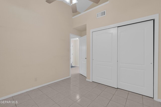 7341 Desierto Rojo Ct, El Paso, TX 79912 - unfurnished bedroom with baseboards, visible vents, a closet, high vaulted ceiling, and light tile patterned floors
