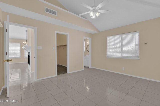 7341 Desierto Rojo Ct, El Paso, TX 79912 - unfurnished bedroom featuring vaulted ceiling, visible vents, a spacious closet, and light tile patterned floors