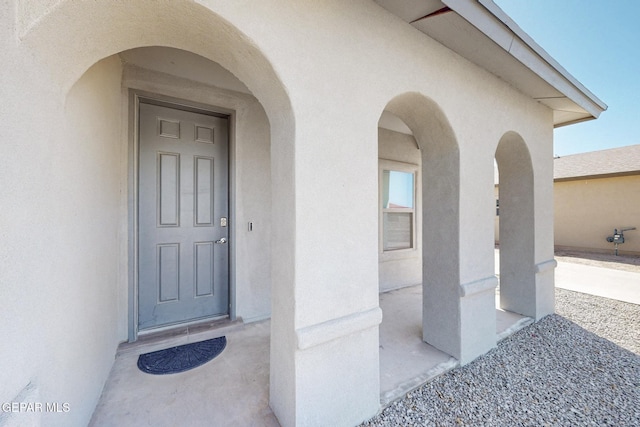 doorway to property with stucco siding