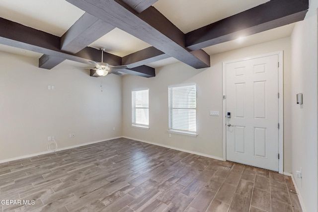 foyer entrance featuring beam ceiling, baseboards, and wood finished floors