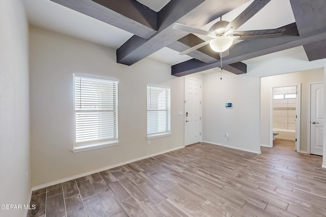 unfurnished room featuring wood finished floors, ceiling fan, baseboards, and beam ceiling