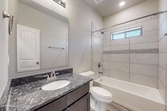 full bath featuring visible vents, toilet, shower / tub combination, and vanity