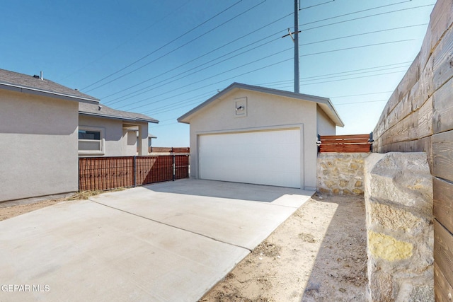 detached garage featuring fence